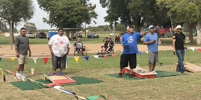 Cornhole players (front, l-r) Bubba Morin, Jonathan Lujan, Fabian Avolas, Locadio Luerra and Jason Hernandez warmed up for their first matches while (seated, l-r) Jonathan Farmer and Tye Farmer watched at the Diez y Sies de Septiembre celebration held in North Park this weekend.