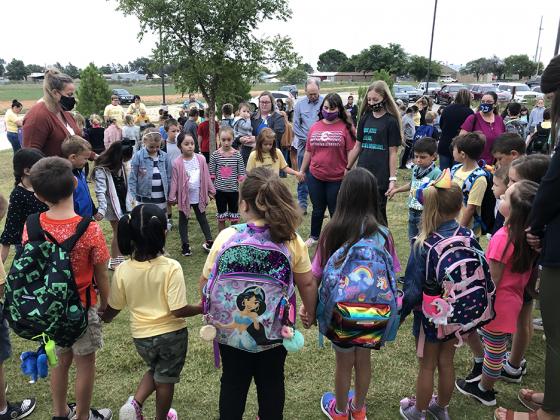 Ira ISD students and staff prayed as a group at the district’s See You at the Pole rally before school Wednesday. About 250 people showed up for the early morning event.