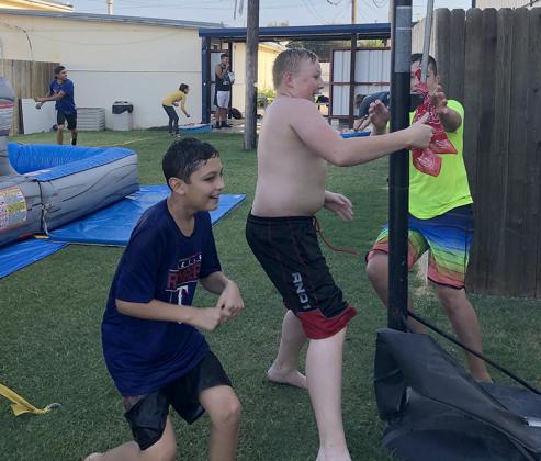 Calvary Baptist Church’s youth group played Capture the Flag with water balloons Wednesday evening. Pictured in front (l-r), Adrien Alanis, Charlie Hughes and Miles Stansell attempted to take a flag tied to a basketball hoop without getting hit while Gerardo Reyes, Bailey Waits, Xander Richardson and Johnnie Stansell (pictured in back) threw water balloons at them.