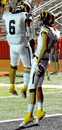 Juniors Jorge Olivarez (left) and Tim Henderson celebrate a Snyder touchdown. henderson finished the game with a receiving touchdown and an interception.