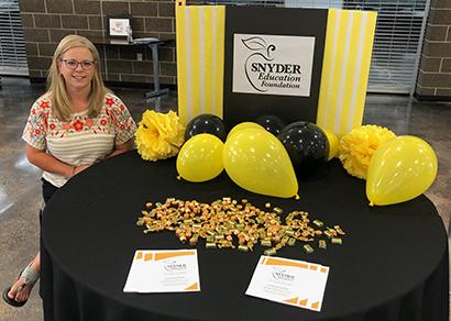 Snyder Education Foundation board member Jami West handed out information about the foundation, which awards classroom grants each year to Snyder ISD teachers.