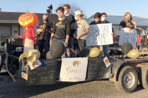 The Snyder High School drama team rode on a float during the SHS Homecoming Parade in Towle Park Friday.