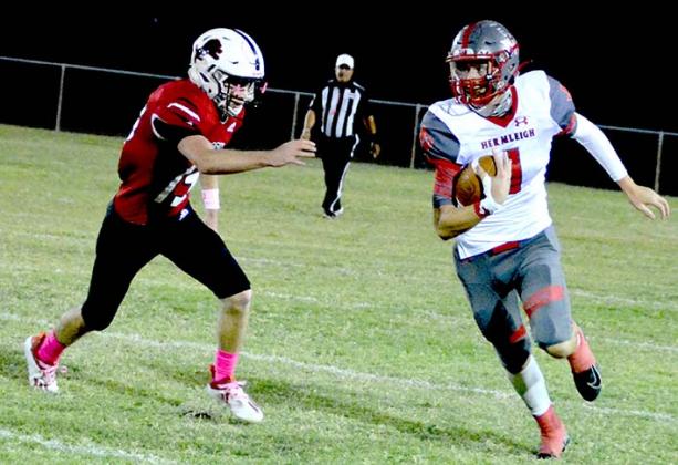Hermleigh junior Stetson Digby runs away from a Roby defender