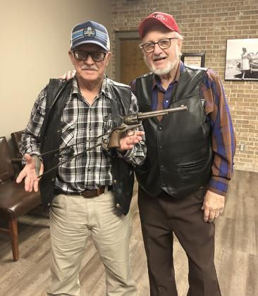 Ernie Fellows (left) and Wendell Grangaard presented a revolver from their collection.
