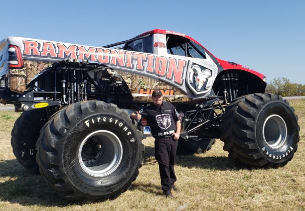 Driver and mechanic Kurt Kraehmer posed Friday with the Rammunition monster truck in front of Blake Fulenwider Chrysler Dodge Jeep Ram of Snyder. Kraehmer and Rammunition were scheduled to put on a car-crushing exhibition at the dealership Saturday afternoon.