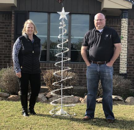 Ann Lintinger (left) and E.J. Lintinger posed with the completed Christmas lights display.