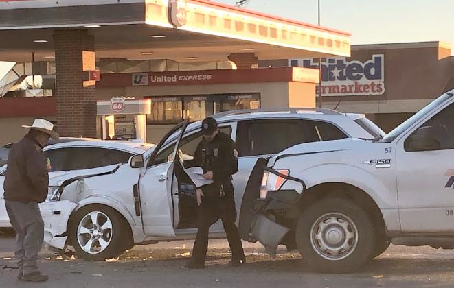 Albert Guzman (left) and Officer Maeson Rojas responded to the scene of a minor two-vehicle accident in the 3500 block of College Ave. at 8:02 a.m. Monday. No injuries were reported.