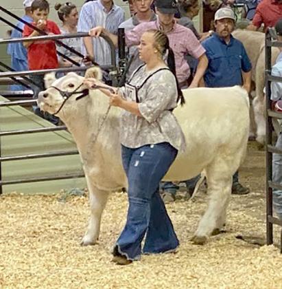 Baeleigh Botts showed her steer, Whitesnake, in a stock show.