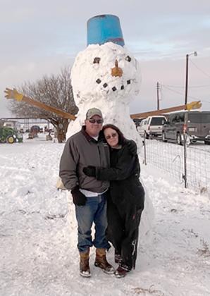 Snyder residents Jerry (left) and Linda Englert built a giant snowman in their yard on FM 1611 with help from their grandchildren during this weekend’s snowfall.