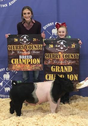 posed with their Grand Champion Pig.