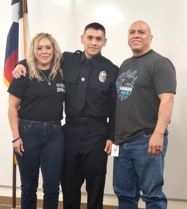 New Snyder Police Officer Nickolas Villa (center) was sworn in and presented with his badge during a brief ceremony Monday morning at the Snyder Law Enforcement Center. The job is Villa’s first position in law enforcement. The new officer is a graduate of South Plains College. In the photo, Villa is pictured with his parents, Isabel Villa (left) and Marcos Villa (right).