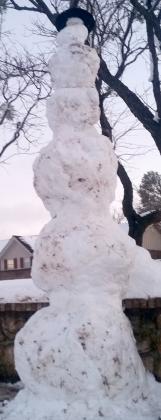 A tall snowman built by the Kerr family in front of their home on Towle Park Road.