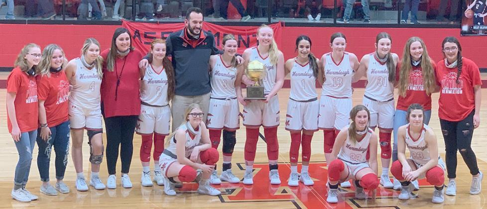The Hermleigh Lady Cardinal girl’s basketball team posed with the trophy after defeating Aspermont, 56-48 for the area championship at Anson High School on Tuesday. Hermleigh will face Eula in the regional quarterfinals at Abilene Wylie High School at 7 p.m. on Thursday.