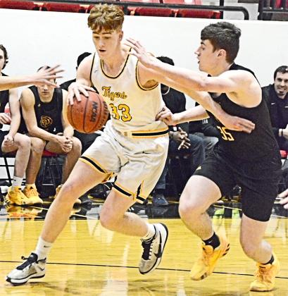 Snyder senior Zach Miller drove past a Seminole defender during the Tigers’ 75-42 loss in the area playoffs at Slaton High School on Wednesday.