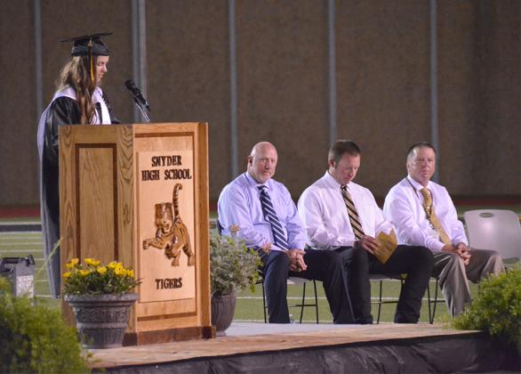 valedictorian Eliza Cowley (left) gave her speech while (l-r) Snyder High School pricipal Shaye Murphy and assistant principals Travis Gregory and David Tate looked on.