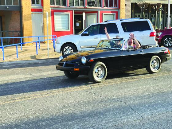 TSN Photos/ Chad Goebel Pictured above Misty Chapman and Jason Chapman waved during the Friday Cruise Night of the car show.