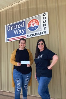 Snyder Community Resource Center program director Jessica Robbins  (left) and Scurry County United Way director Sheila Hale posed with a check.