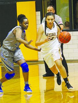 Snyder’s Michelle Rios (right) dribbles past Shatorian Wright of Lubbock Estacado during Friday’s game. The Lady Tigers will play at Big Spring today in a District 2-4A game. The JV Black team will play at 5 p.m., followed by the varsity at 6:30 p.m. The JV Gold team’s game will start at 8 p.m.
