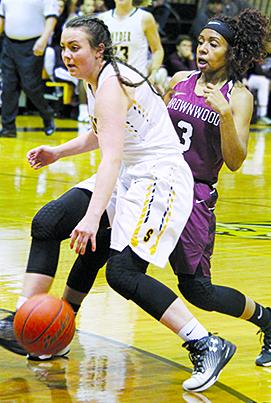 Snyder’s Kristi Pierce drives past Brownwood’s Daisy Green during Friday’s game. The Lady Tigers lost to Brownwood, 70-22.