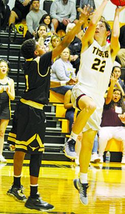 Snyder’s Nathan Kendrick (22) shoots over Big Spring’s Javone Ford during Tuesday’s game. Kendrick scored 16 points in the Tigers’ 55-44 win.