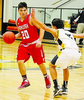 Hermleigh’s Matt Gonzalez (20) drives around a Loraine defender last week.  The Cardinals will start the second half of the District 12-1A schedule by hosting Westbrook today.