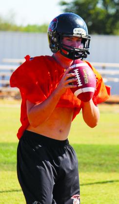 Ira junior Hunter Cotton grips the football during practice. Cotton is one of the players that played a key role in the Bulldogs’ 7-0 record during the non-district schedule, said head coach Toby Goodwin.