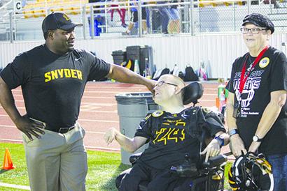Snyder High School graduate Jonathan Barrow (center) received words of encouragement from head football coach James Polk prior to fulfilling his dream of scoring a touchdown for the Tigers. Also pictured is Barrow’s mother, Suzanne.