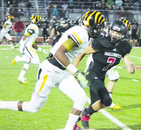 Snyder receiver Abram Smith (left) tries to get away from J.D. Townsend of Shallowater.