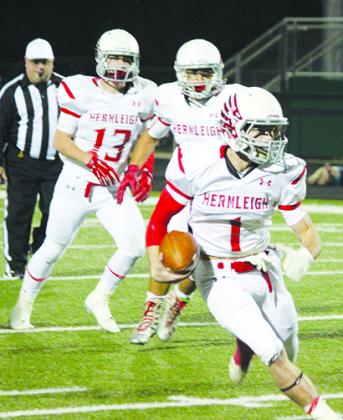 Hermleigh’s Coletyn King (1) runs in the open field during Friday’s Class 1A Division I regional playoff game against Garden City. Teammates Kyler Roemisch (13) and Colt Mallory watch as King runs the ball. The Cardinals’ season ended with a 94-44 loss to the Bearkats.