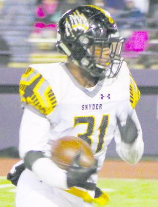 Snyder running back J.J. Burns, who rushed for 118 yards, looked for running room during Friday’s game at Pecos.