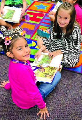 Valentina Narvaez (left) and Kambree Sandoval read to each other Thursday in Magdalena Jaimez’ Spanish language arts class. 