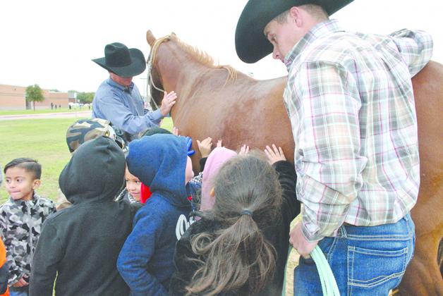 In his downtime, Garrett Hale enjoys talking to kids about the rodeo life. He and his parents, Van and Becky Hale, brought his trailer and horse to career day at Snyder Primary School.