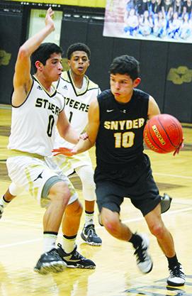 Snyder’s Trey Samaniego (10) drives against Big Spring’s Dimas Garcia during Friday’s game. The Tigers ended the season with a 51-33 loss to Big Spring.