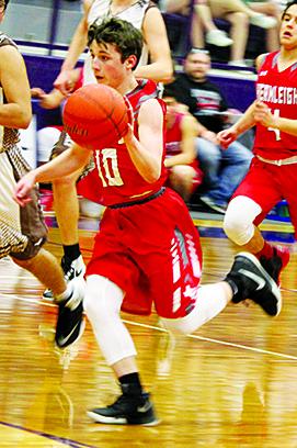 Hermleigh’s Kelton Carroll (10) dribbles down the court against Ackerly-Sands. The Cardinals lost to Sands, 37-34.