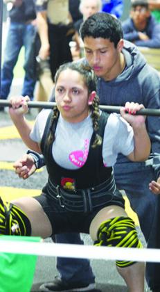 Snyder’s Diamond Escobedo executes a squat at last weekend’s Snyder Tiger Powerlifting Invitational. Escobedo is leading her weight class in Division 2 Region 1.