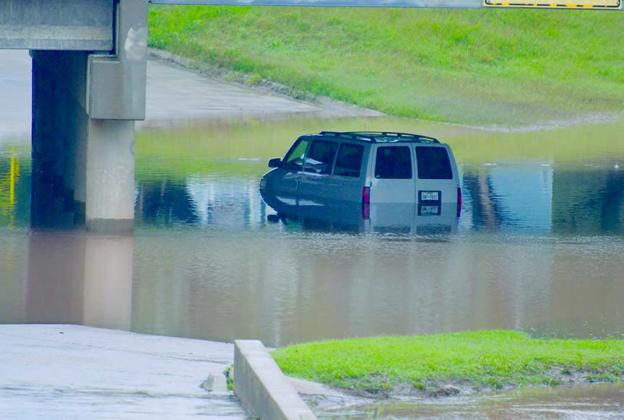 A vehicle was abandoned after it became stuck in high water at the 28th Street underpass of the Deep Creek bridge on College Ave. early today. Heavy rains have caused many low water crossings in Snyder to become flooded and motorists are advised to exercise caution in those areas.