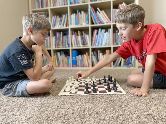 Teddy Kerr (left) and Archie Kerr face off against each other during one of their practice chess games.