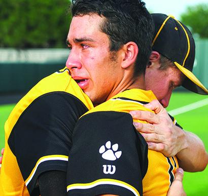 Snyder’s Logan Tate and Matt Bass embraced after Saturday’s 9-3 loss to Abilene Wylie in Game 2 of the Region 1-4A semifinal series. 