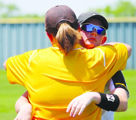 Snyder senior Shayde Millican hugs assistant coach Amanda Parsons after the Lady Tigers lost to Brownwood in the Region 1-4A championship series Saturday.