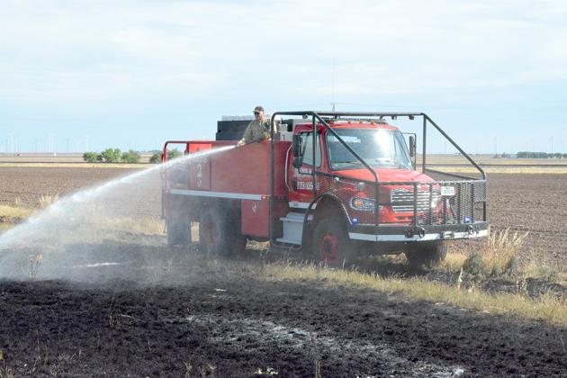 Snyder Fire Department Lt. Gary Colvin put out flames near the intersection of U.S. Hwy. 84 and CR 4106 from atop a brush truck on Thursday morning. Deputies from the Scurry County Sheriff’s office also responded.