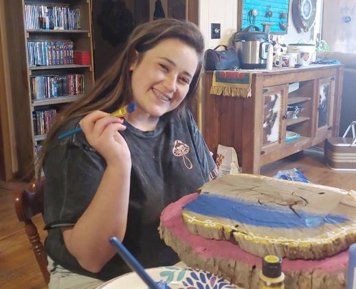 Brooke Thompson painted one of the fairy doors in preparation for a fairy to be placed inside.