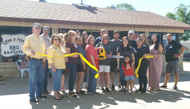 Snyder Chamber of Commerce employees and Gold Coats held a ribbon cutting at Gran and Pop’s Barbecue and Burgers, 3812 College Ave., on Saturday. Pictured, from left, are Charles Ragland, David Molina, Janet Spence, Rose Ragland, Linda Molina, Leslie Franklin, Sadie Robertson (back), Bethany Robertson, Jodi Powell, Ryan Anderson, owners Marti “Gran” Anderson and Stewart “Pop” Anderson, Rylan Martinez, Sophia Guerra, Vivianna Anderson, Dakota Carroll, Jaeda Carroll, Sandra Salinas, Summer Grimmett and Josh O