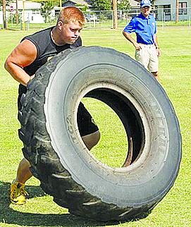 Snyder’s Sean Humphrey flips a tire during one of the summer tournaments. 