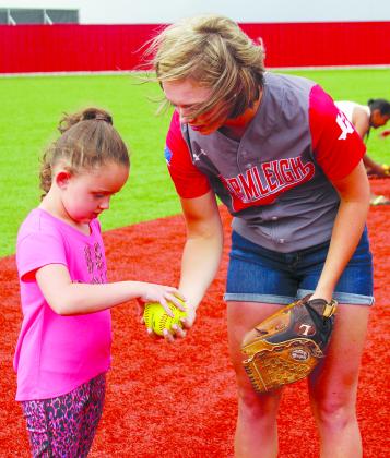 Baylee McClure (left) talks with Hermleigh senior pitcher Kelsey Digby during Wednesday’s thank you pep rally. The Lady Cardinals will play Dodd City at 11 a.m. Friday in the state semifinals at Mary Hardin-Baylor’s Dee Dillon Field in Belton. 