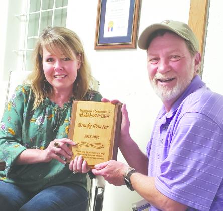 Resigning DCOS Executive Director Brooke Proctor (left) accepted a plaque commemorating her time on the job from DCOS board president Bill Robertson. June 30 will be Proctor’s last day.