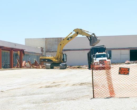 Construction crews demolished a significant portion of the Varsity Square Shopping Center Tuesday afternoon. According to Snyder City Manager Merle Taylor, the Family Dollar store and the defunct Outlaw Cheer School will remain, while the rest of the buildings will be torn down.