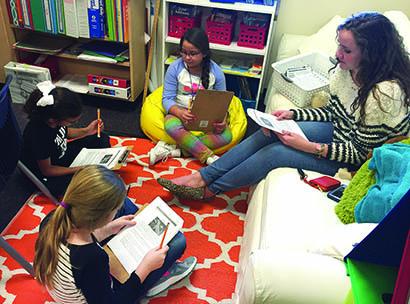 Pictured are (l-r) Izzy Byrd, Landrie Polk and Keeley Guzman going over a reading assignment with Snyder High School junior Anna Charlotte Lavers.