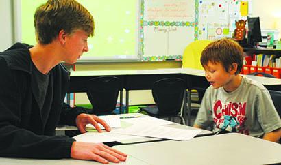 Snyder High School junior Corbin Shaw (left) and Snyder third grade student David Couch practice reading techniques at Reach for the STAAR on Thursday.