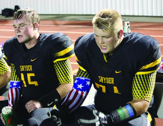 Snyder linebacker Daniel Drake (15) and defensive tackle Sean Humphrey (71) take a break on the sidelines during last week’s game against Monahans.
