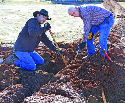 Big Country Electric Cooperative employees Jon Tate (left) and Randy Lambert  installed electric lines at Heritage Village. The project will be completed in time for the Dec. 10 Ye Ole Village Lighting ceremony.